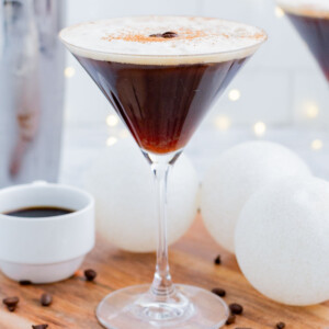 An espresso martini is served in a tall martini glass.