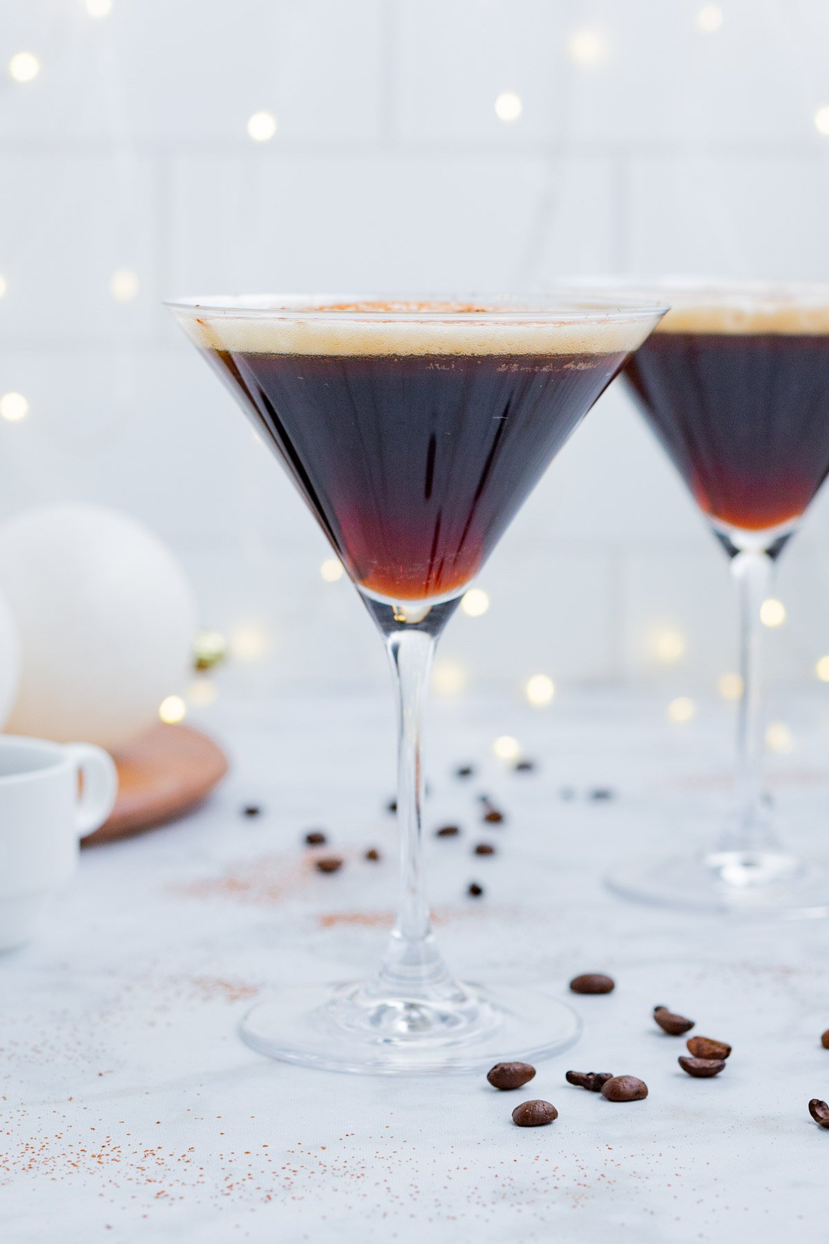Two glasses of espresso martini are served.