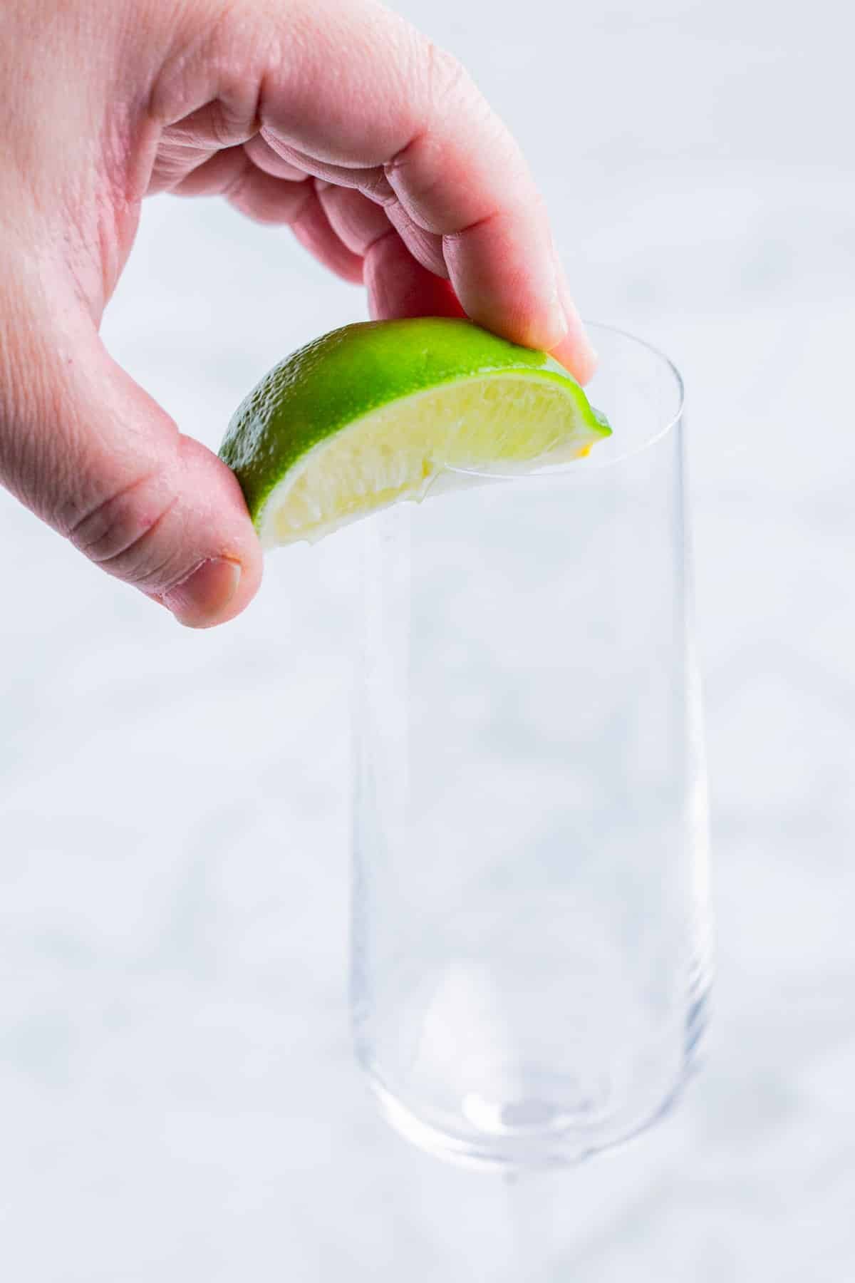 A lime is used to wet the rim of a flute.