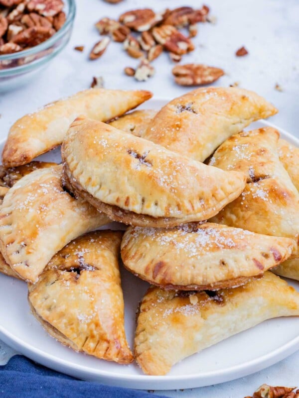 A plate full of pecan hand pies is ready to be served.