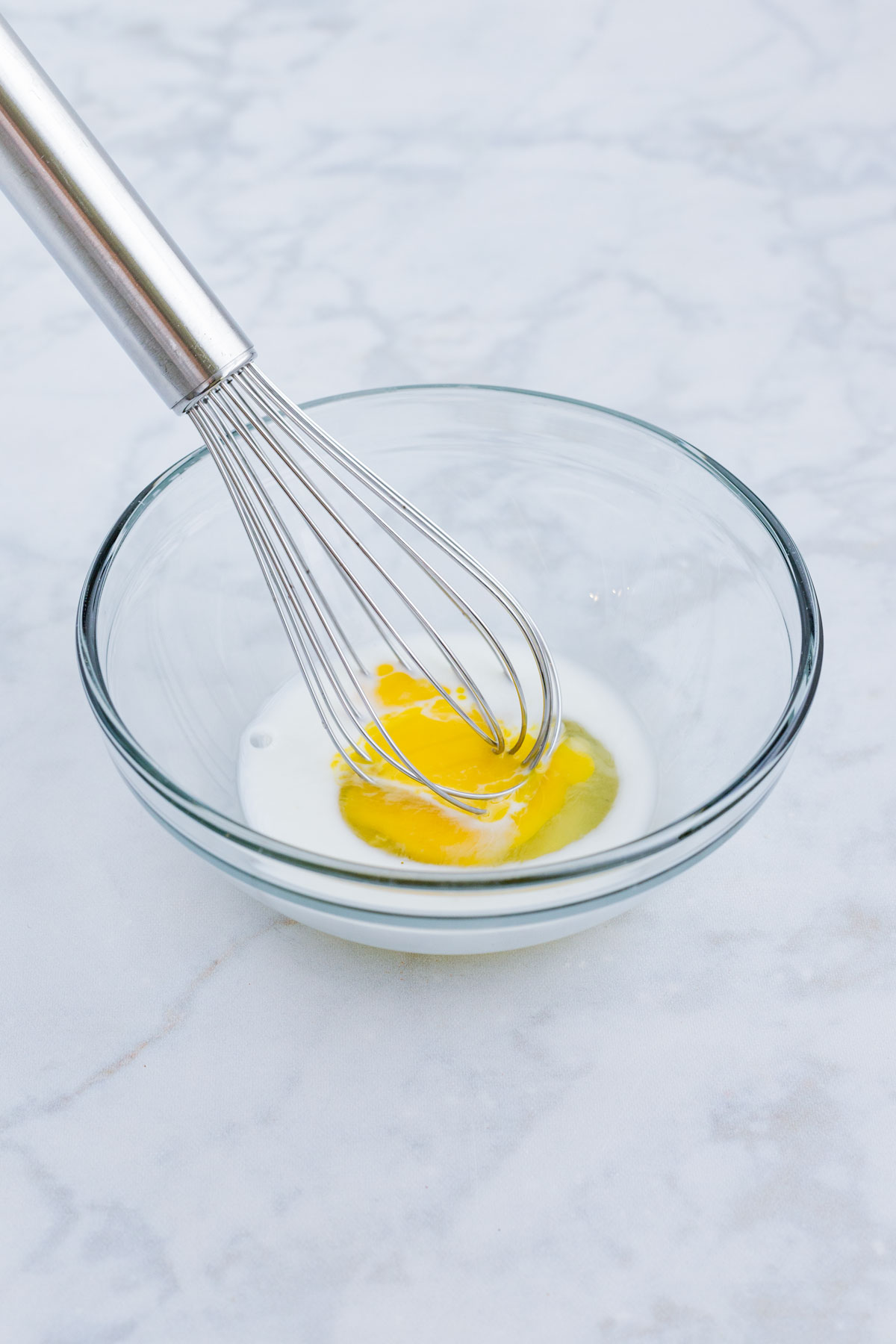 Egg and milk are whisked together.