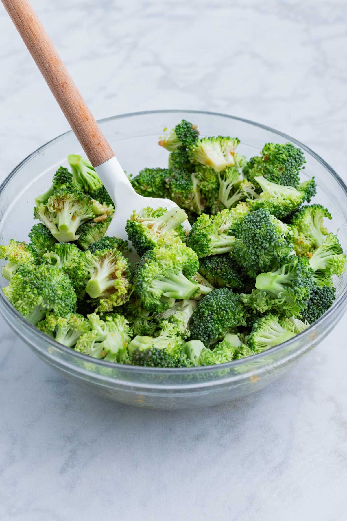 Broccoli florets are tossed in a honey butter sauce before roasting in the oven.