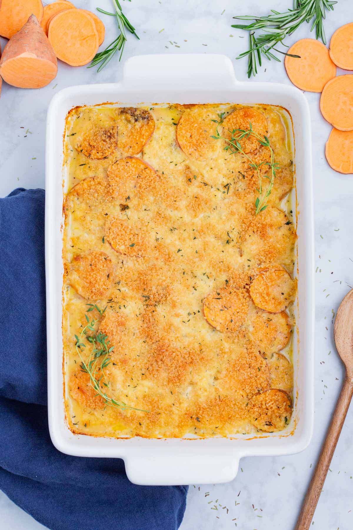 Sweet potato au gratin is baked in a casserole dish.