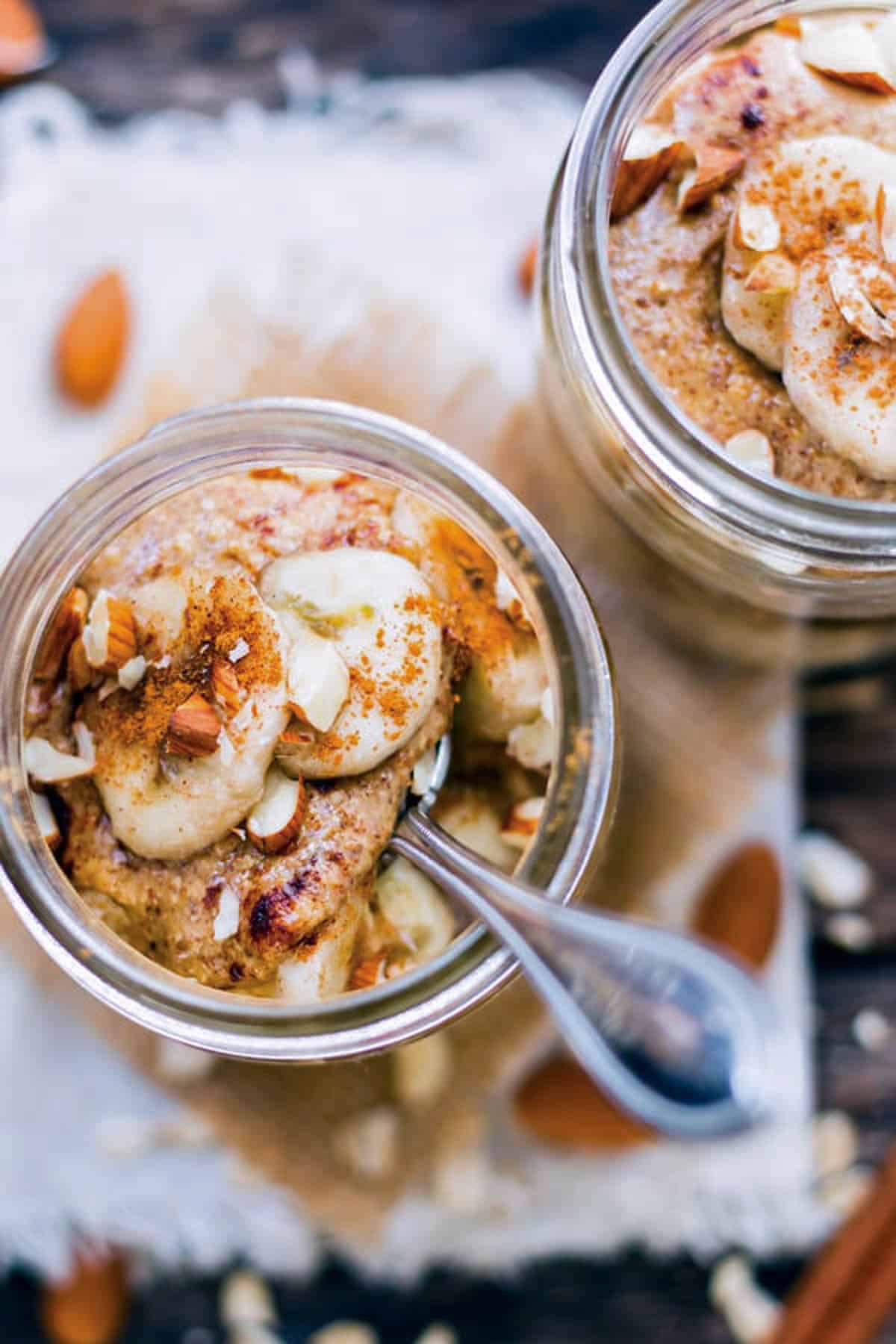 An overhead picture of oatmeal in a jar with a spoon inside.