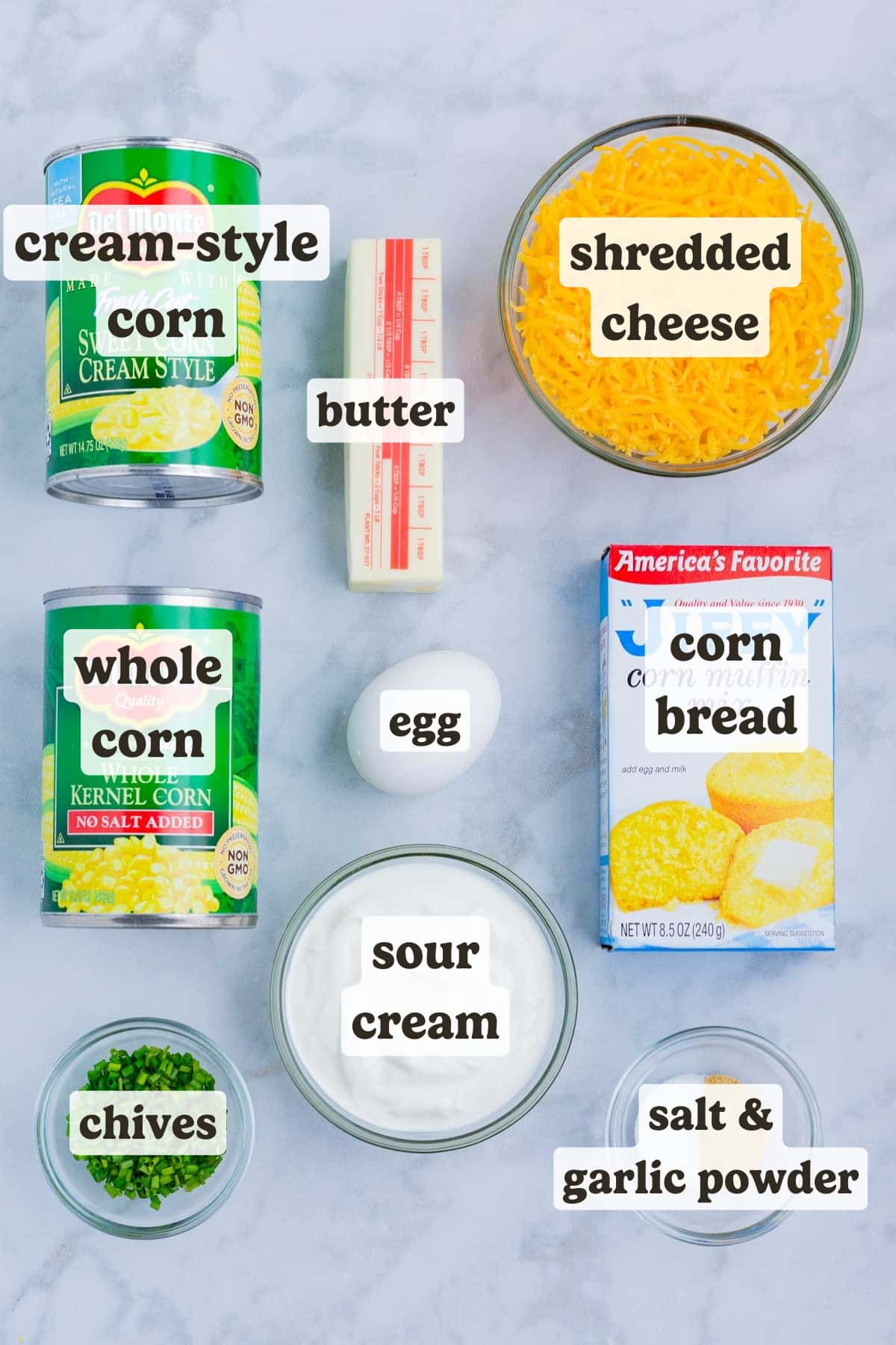 Corn, creamed corn, butter, cheese, cornbread, and herbs are the main ingredients for this corn souffle dish.