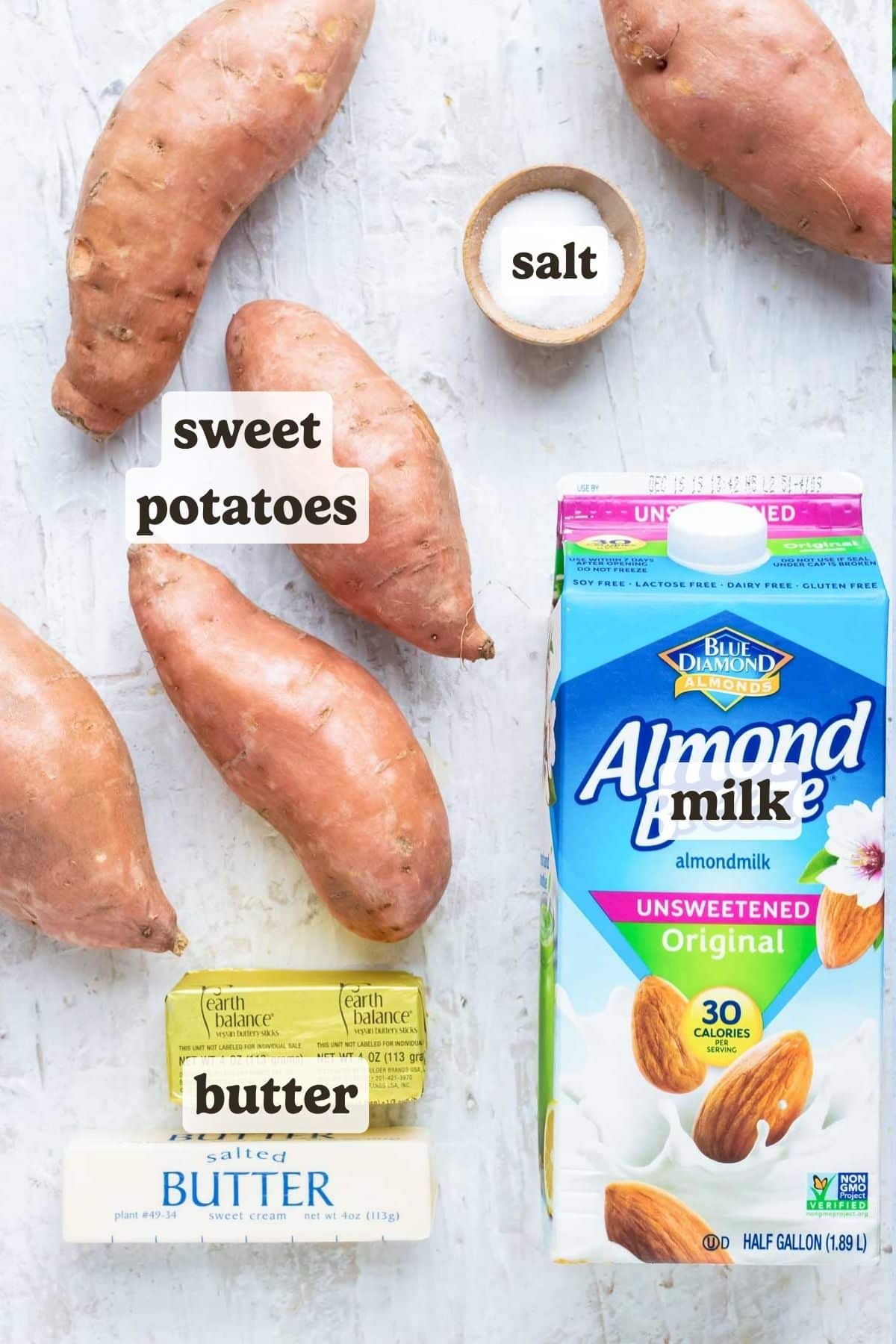 Sweet potatoes, milk, butter, and vegan butter laid out for an easy mashed sweet potatoes recipe.