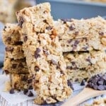 A stack of gluten-free peanut butter granola bars on parchment paper.