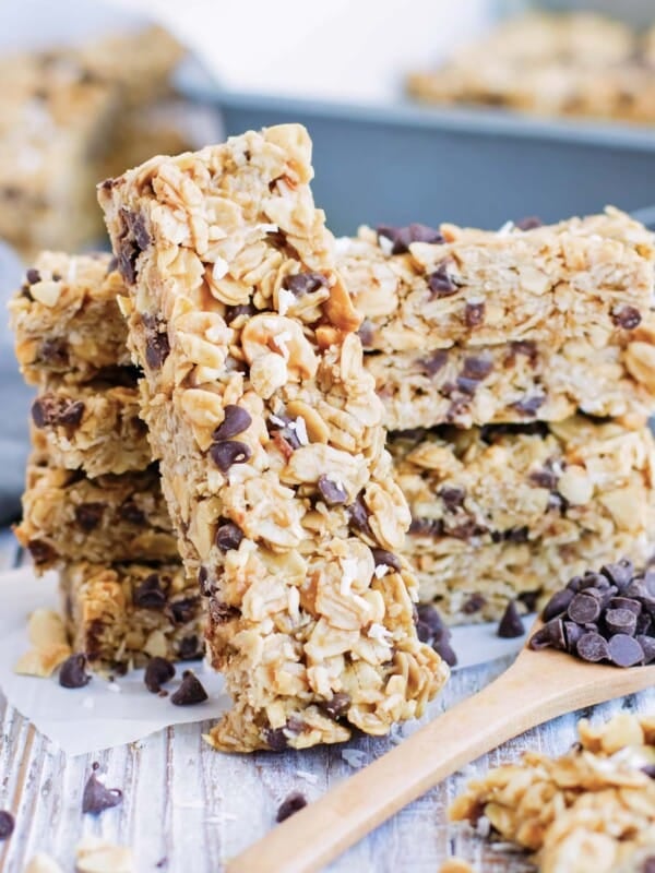A stack of gluten-free peanut butter granola bars on parchment paper.