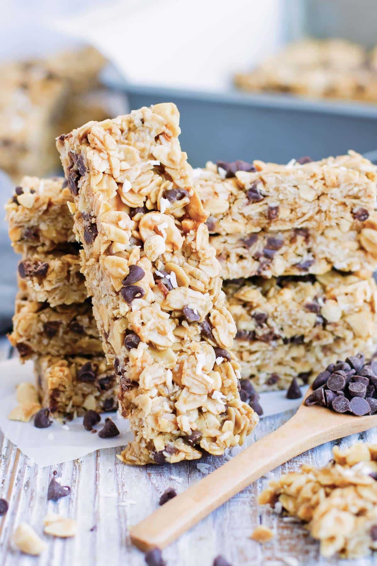 A stack of gluten-free peanut butter granola bars on parchment paper.