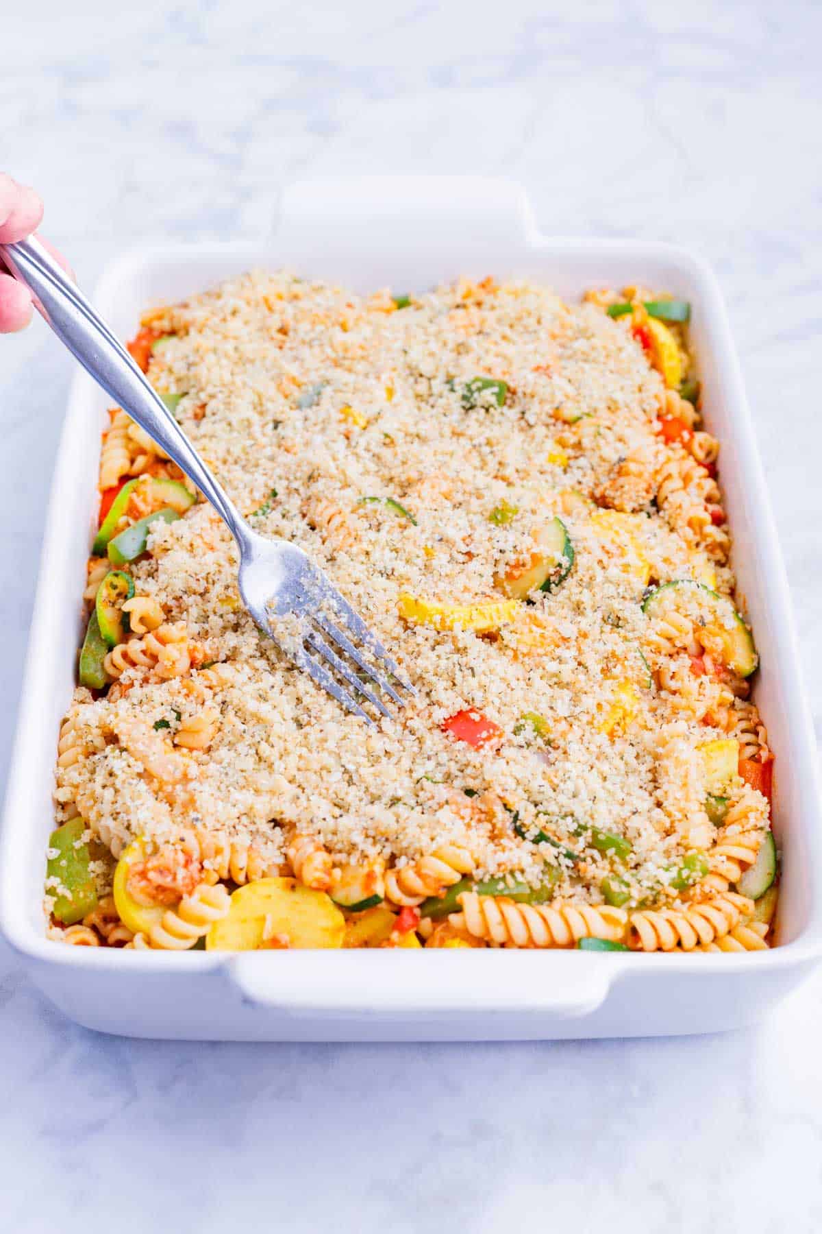 Breadcrumbs are spread across the top of the pasta.