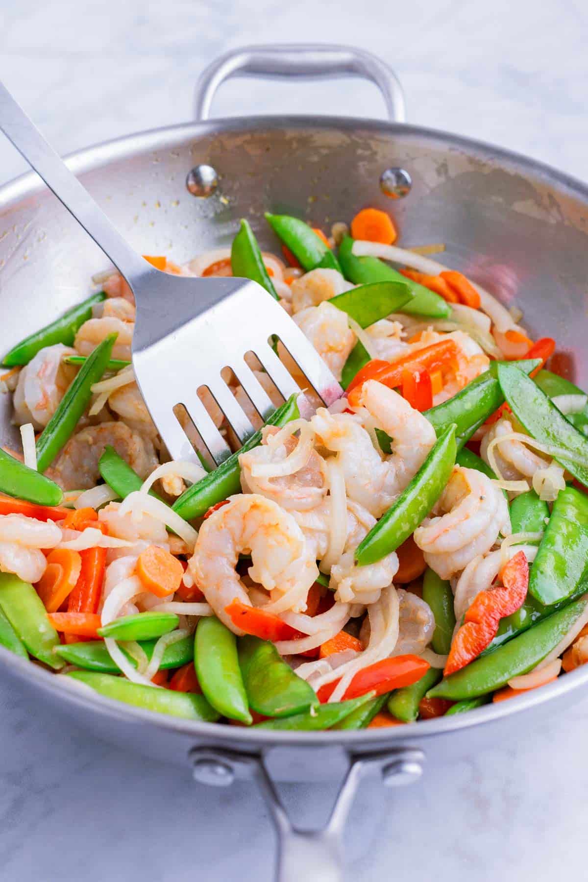 Shrimp is stirred into the veggies.