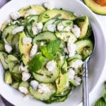 A cucumber crab and avocado salad is served with fresh mint and lime juice for an easy summer side dish.