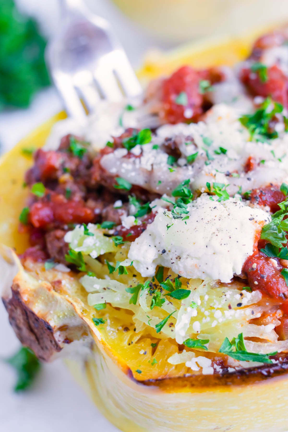 Lasagna Spaghetti Squash boats are packed with ground turkey or ground beef, tomato sauce, and cheese.