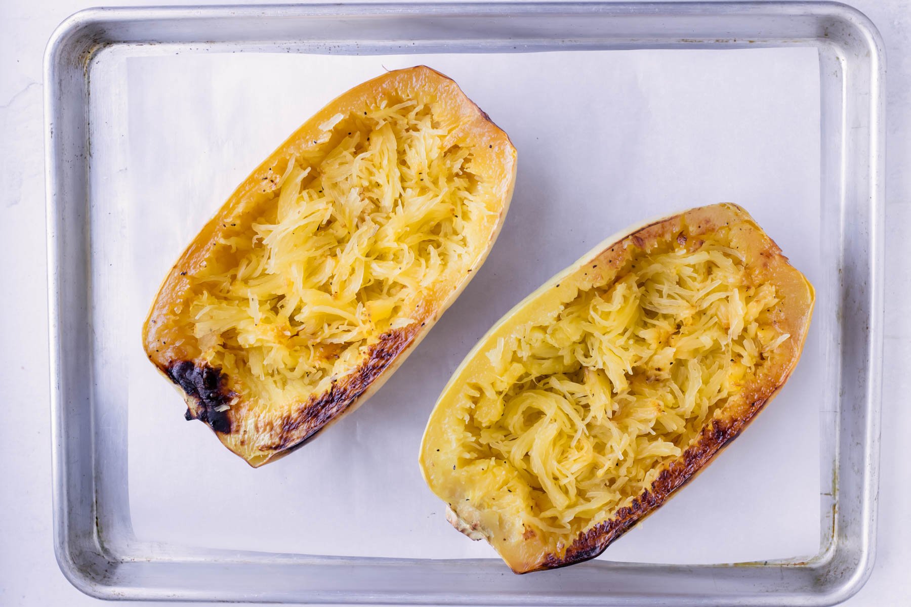 Roast spaghetti squash in the oven on a large baking sheet.