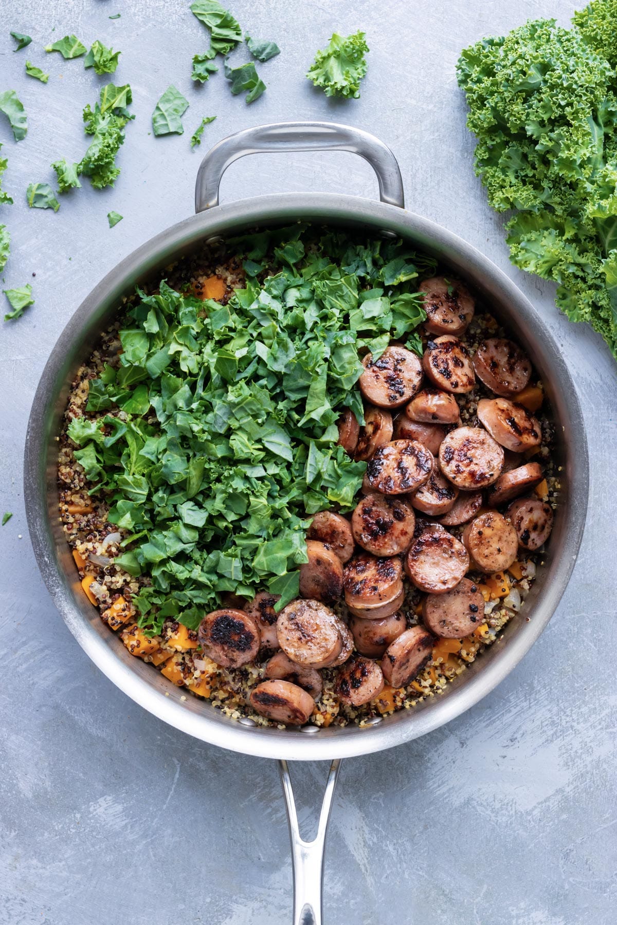 Sausage and kale are added to the sweet potato and quinoa mixture.