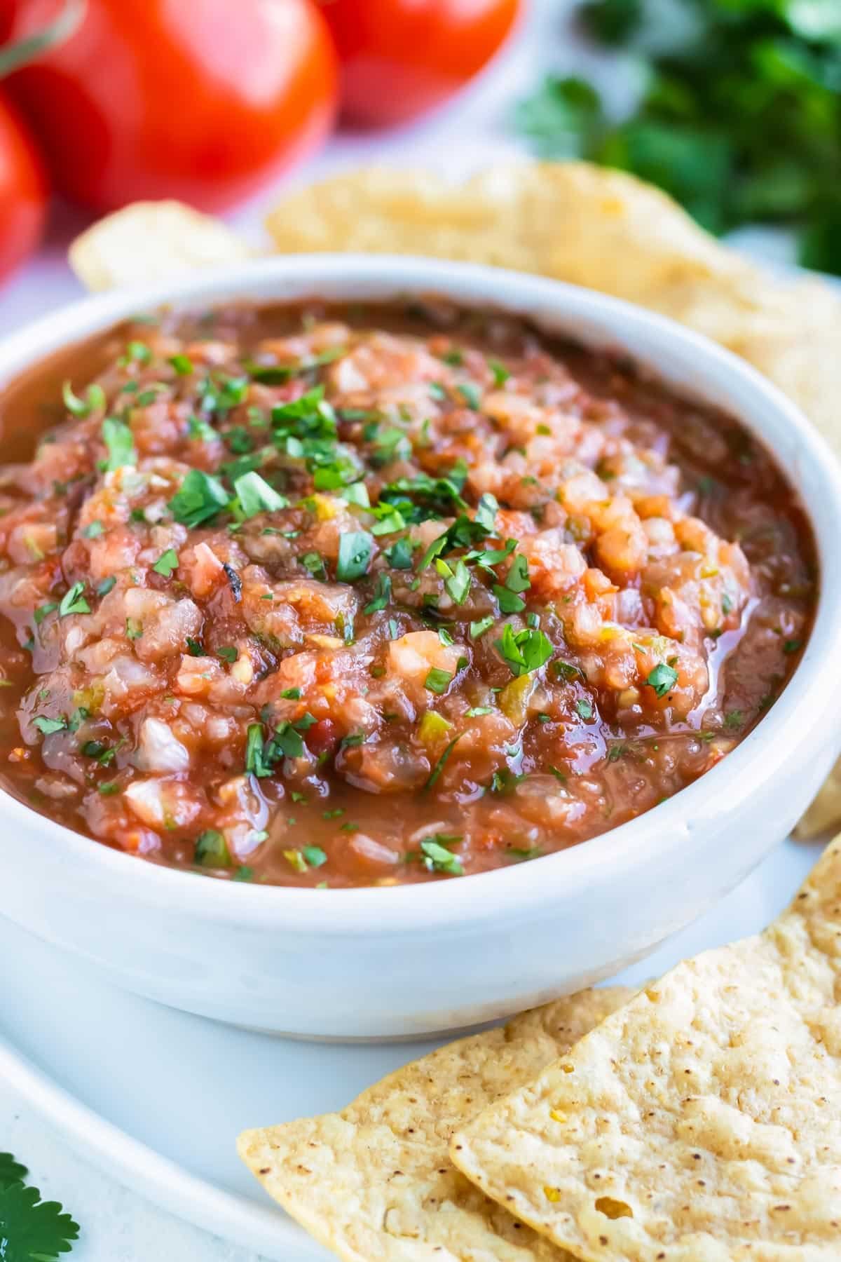 Homemade Salsa with Roasted tomatoes is served as a dip with tortilla chips.