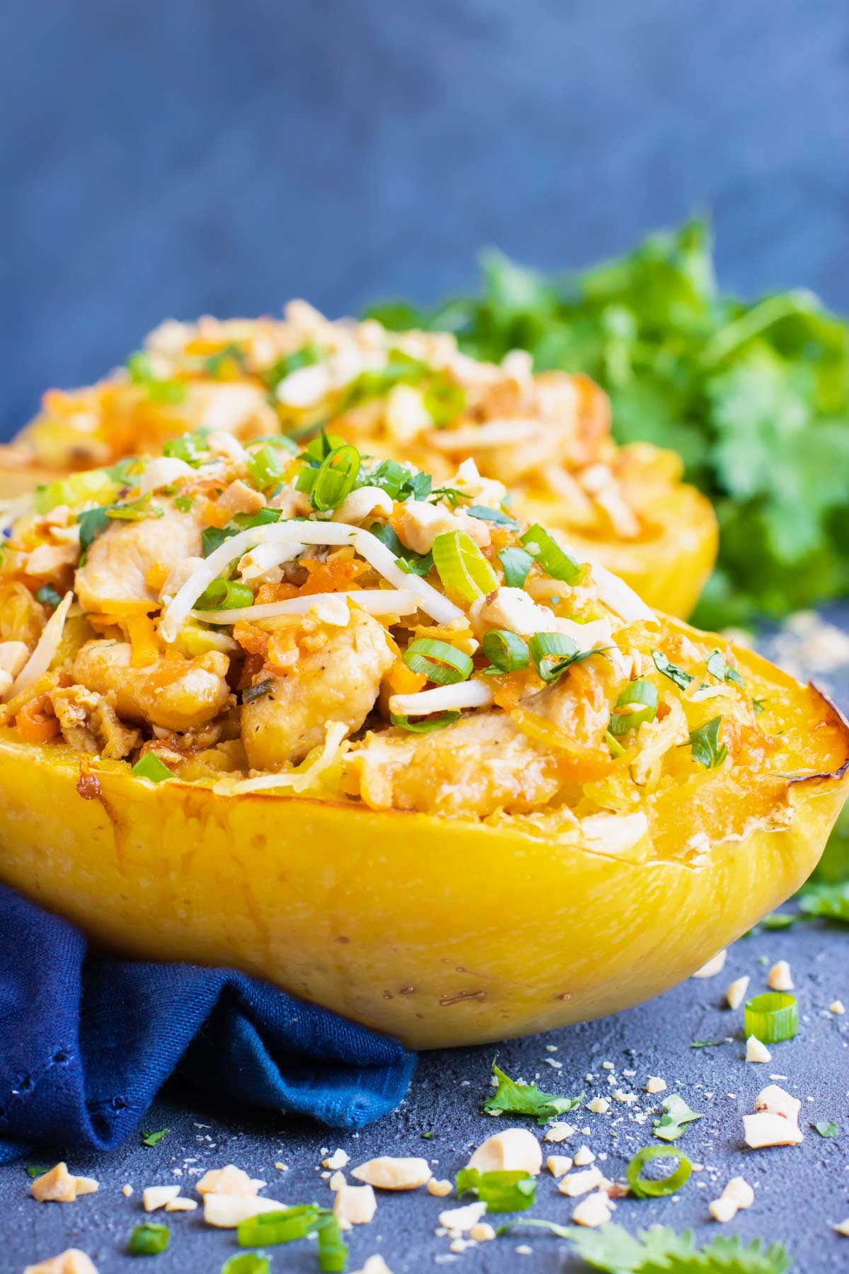 Gluten-free spaghetti squash pad thai with chicken on a blue napkin.