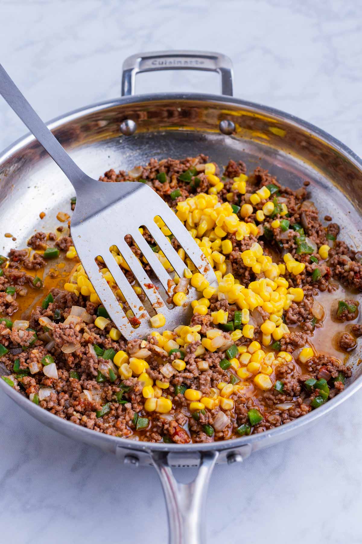 Corn is added to the beef and veggie mixture.