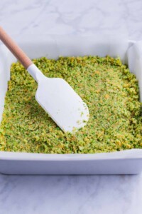 The broccoli mixture is spread across a pan.
