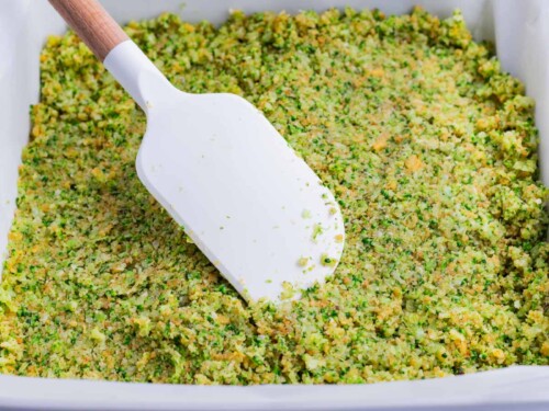 The broccoli mixture is spread across a pan.