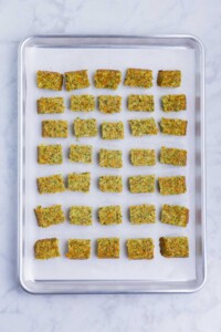 Partially baked broccoli tots are sliced and baked again.