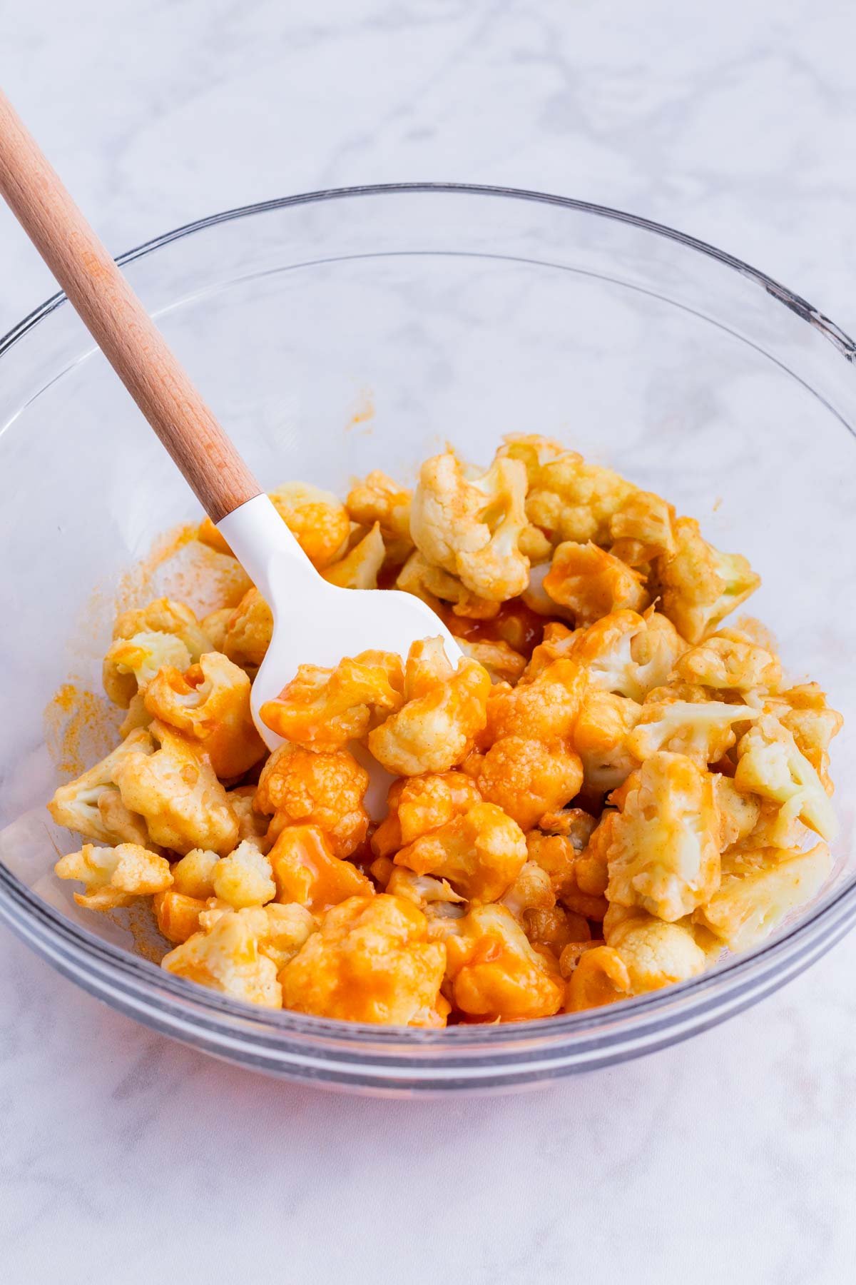 Cauliflower bites are tossed in buffalo sauce.