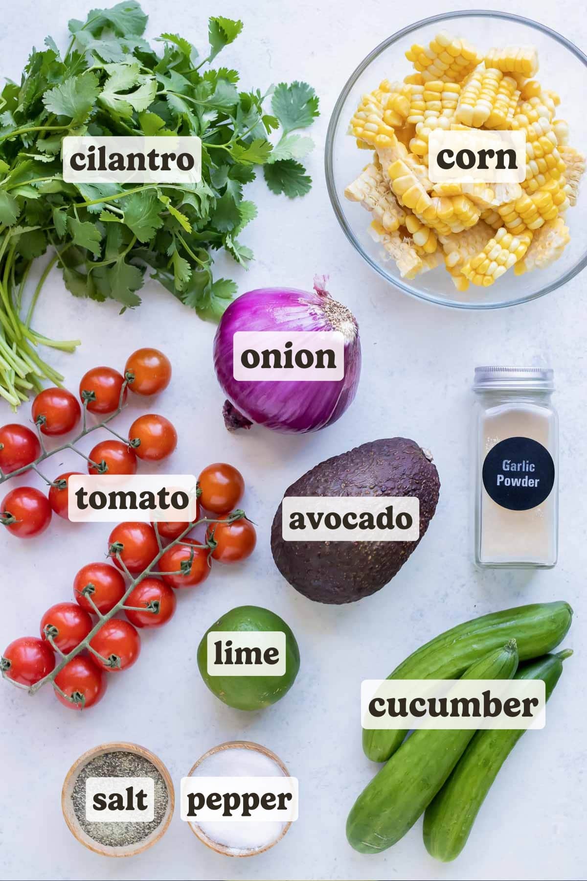 Avocado, tomatoes, lime juice, cucumbers, cilantro, red onion, and corn are the ingredients for this avocado corn salad.