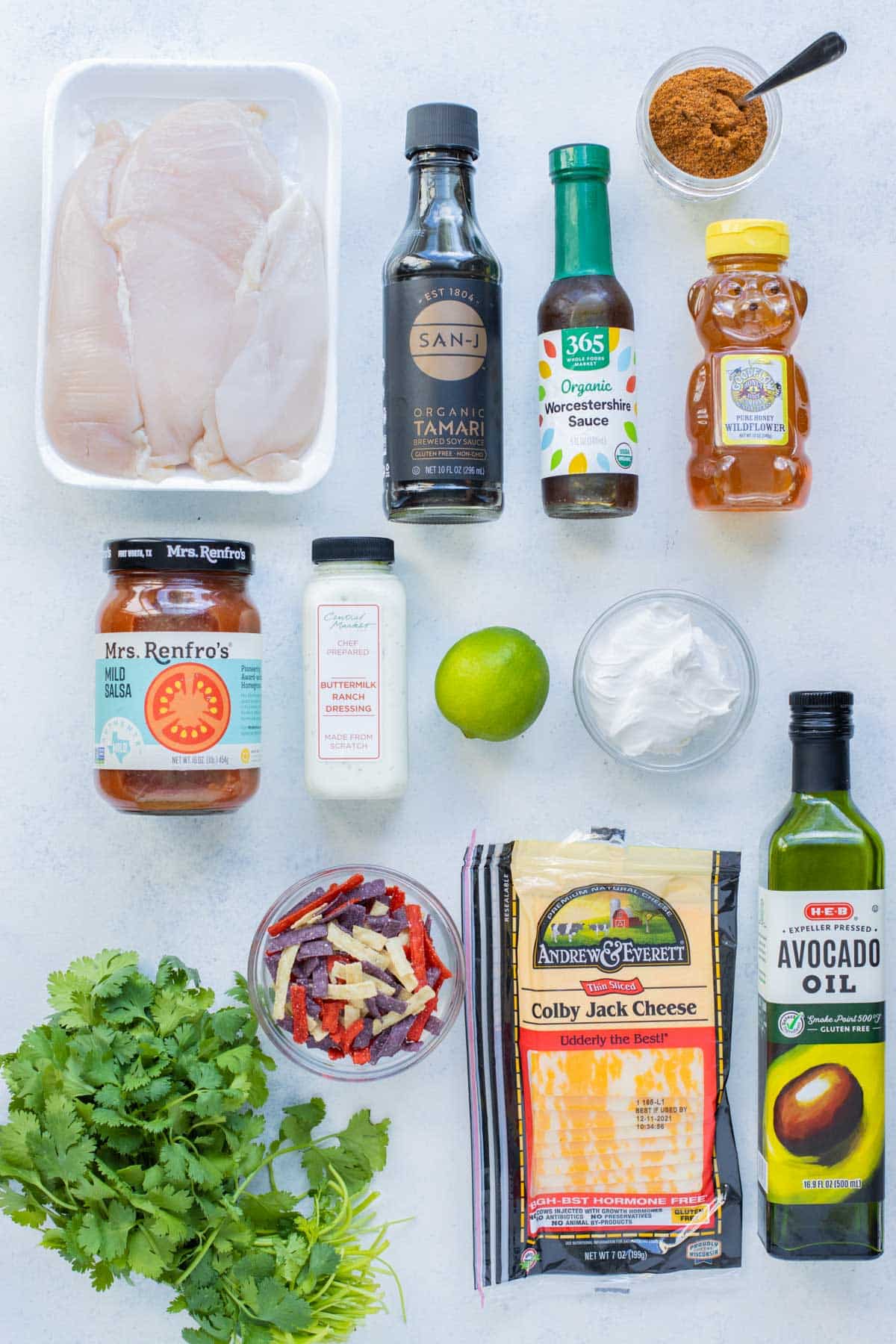 Honey, chicken, salsa, lime juice, oil, sour cream, cilantro, salsa, cheese, and tortilla chips are the ingredients for this recipe.