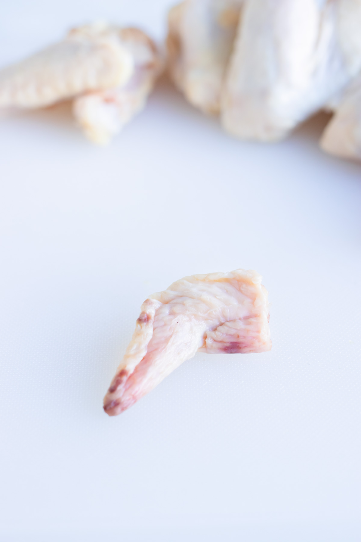 The tip of a chicken wing is shown on the counter.
