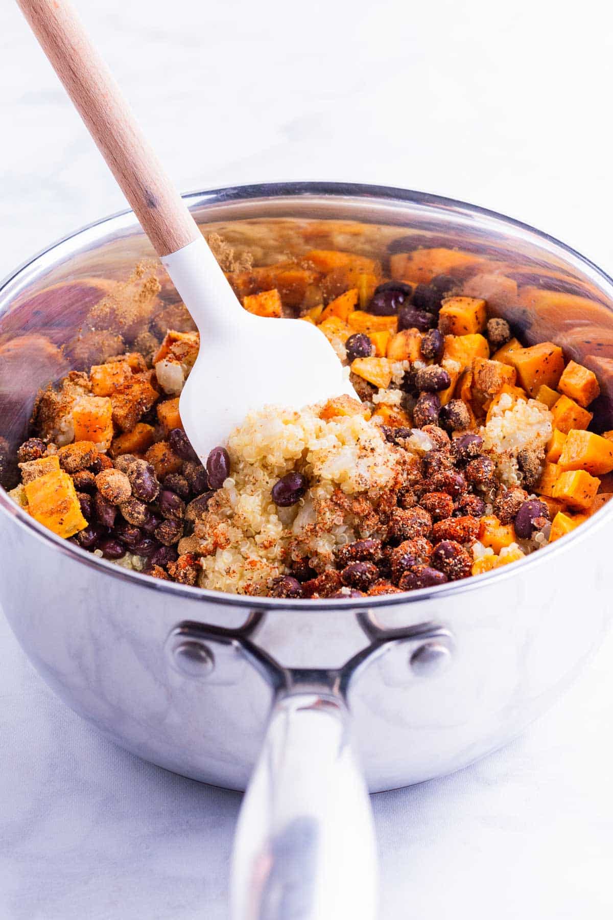 Black beans and sweet potato are stirred into the filling mixture.