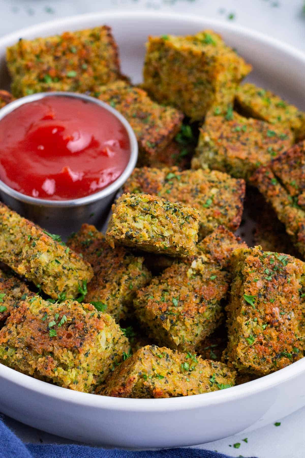 Easy Broccoli Tater Tots RECIPE served in a white bowl with Ketchup.