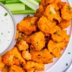 Cauliflower buffalo bites are served alongside celery sticks and ranch.