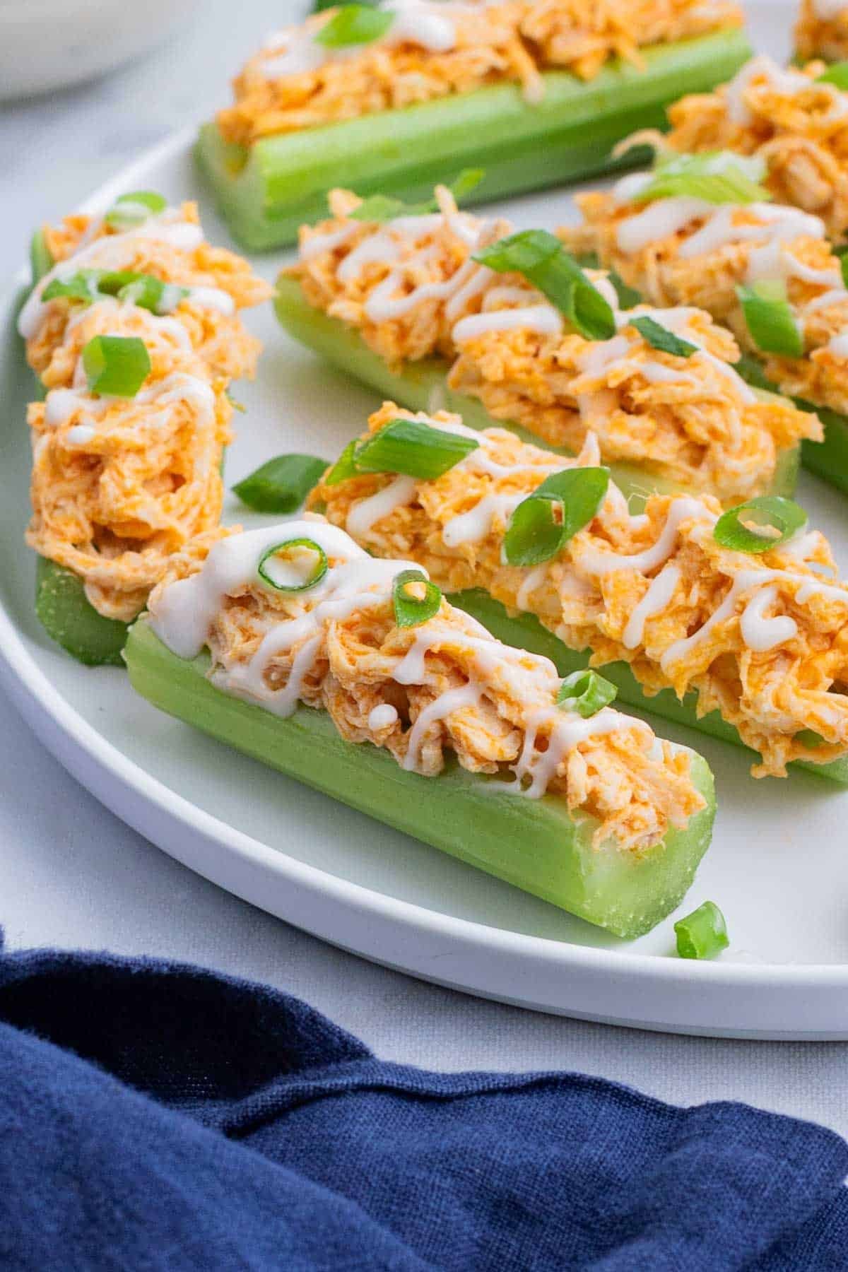 A plate is full of buffalo chicken-filled celery.