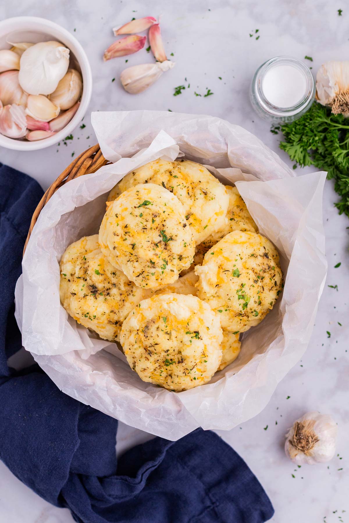 A basket of cheddar bay biscuits are served.