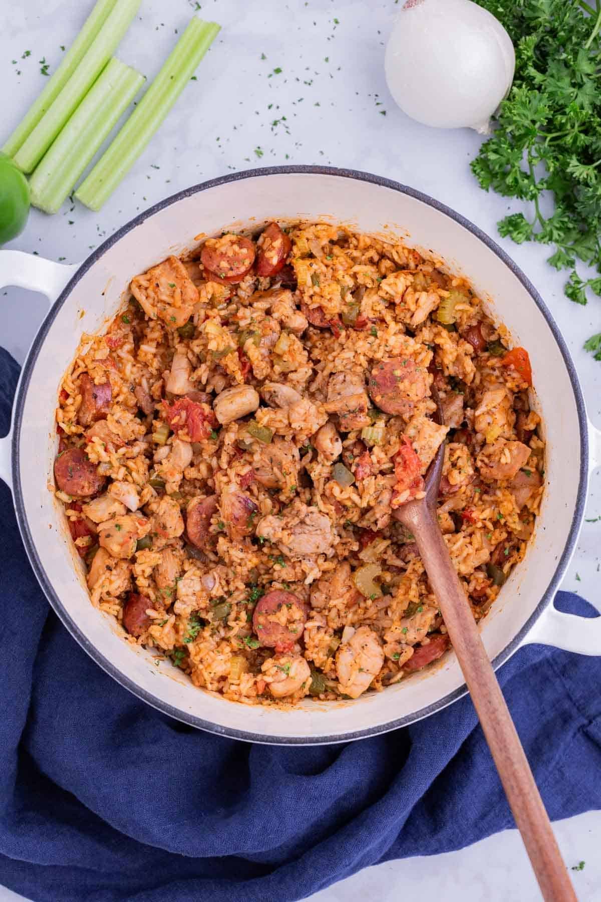 A Dutch oven full of a sausage Jambalaya recipe for a Cajun Mardi Gras party.