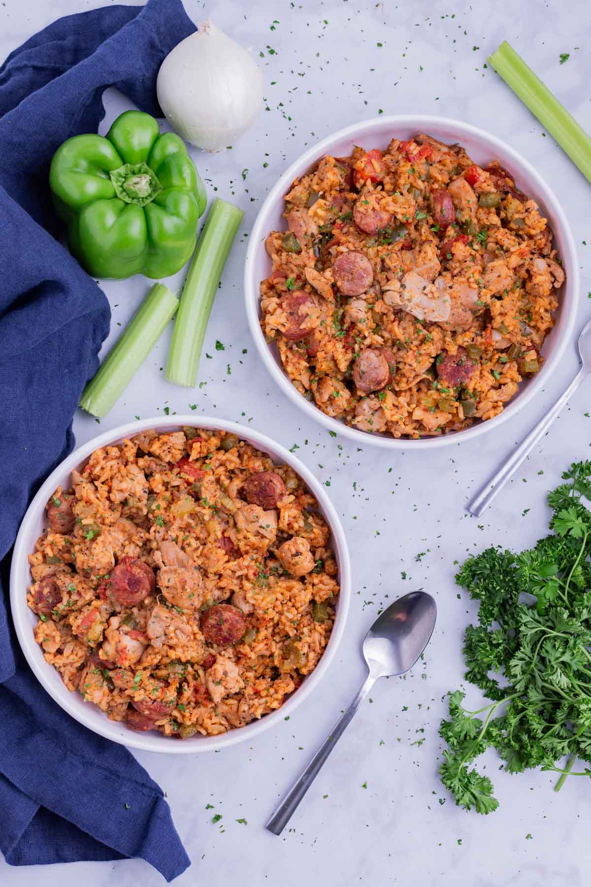 Two bowls are full of chicken and sausage jambalaya.