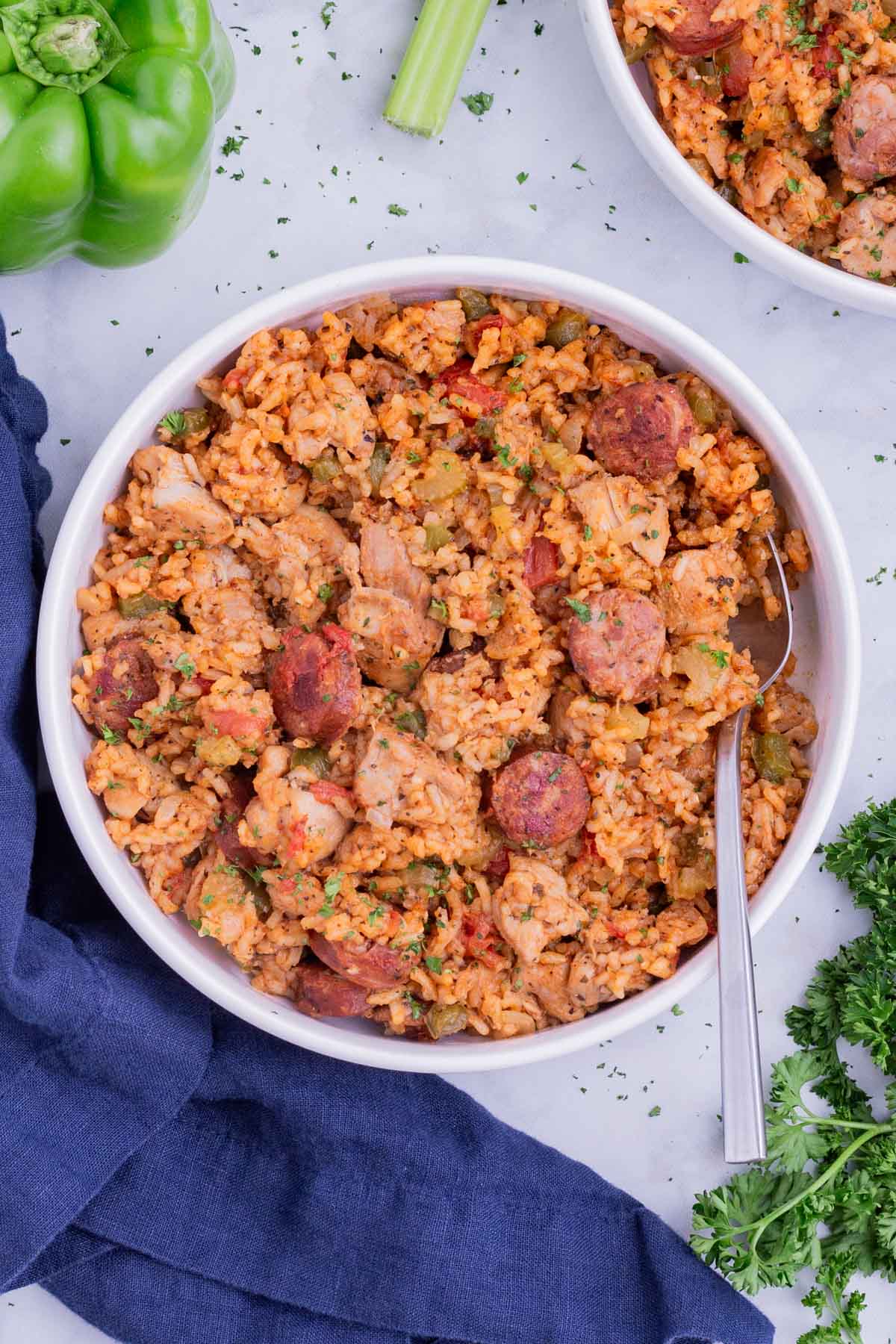 Chicken and sausage jambalaya is served in a white bowl.
