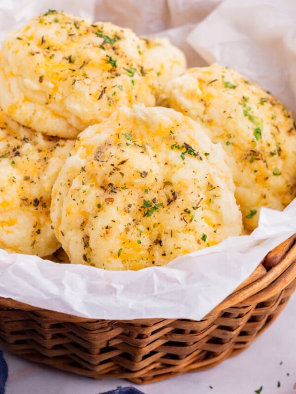 A basket of cheddar bay biscuits are served.