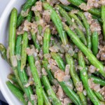 Green beans with vinegar are served in a white bowl.