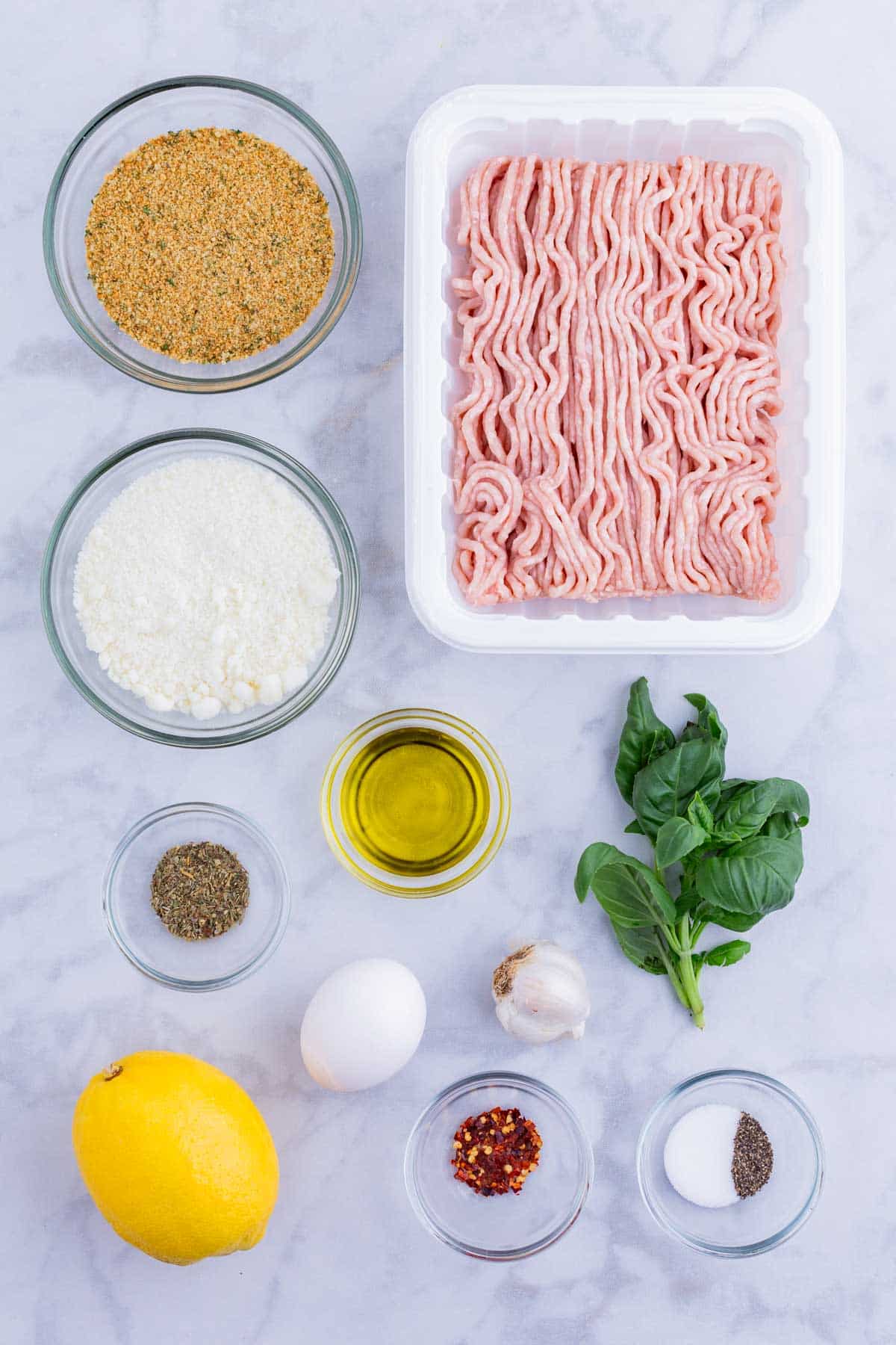 Ground chicken, breadcrumbs, Parmesan cheese, basil, and seasonings are the main ingredients for this dish.