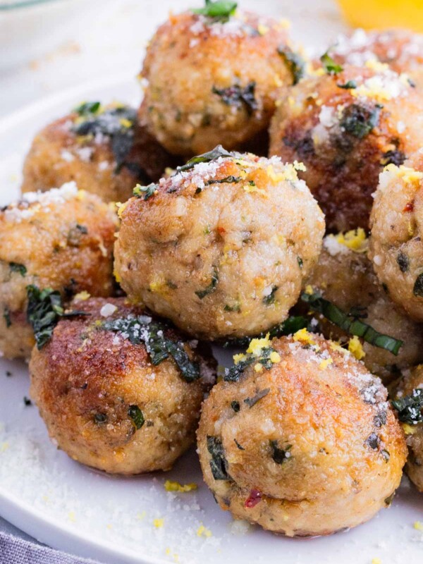 Meatballs are made with ground chicken and Parmesan cheese and served as an appetizer.
