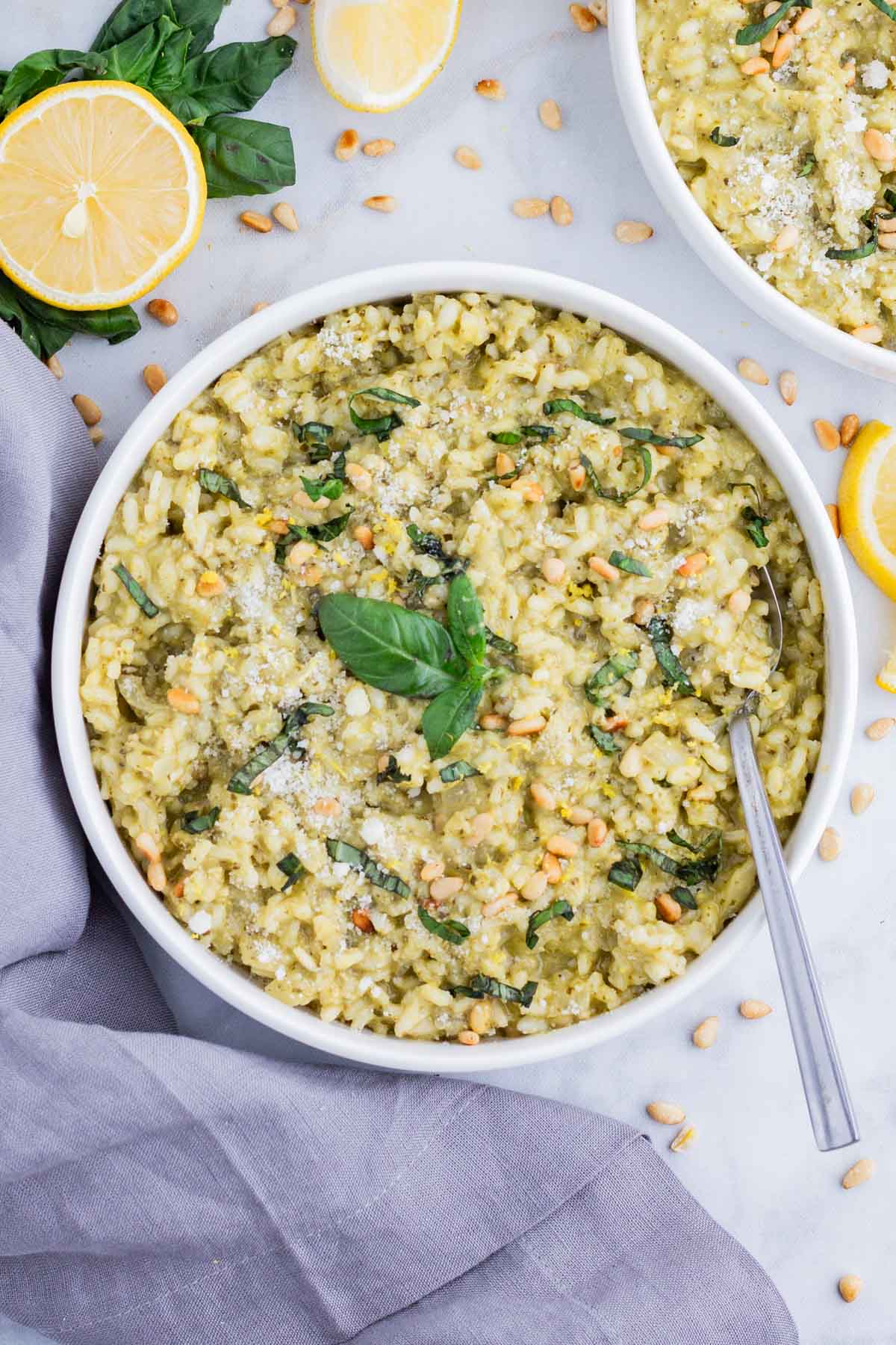 A spoon is used to serve pesto risotto.