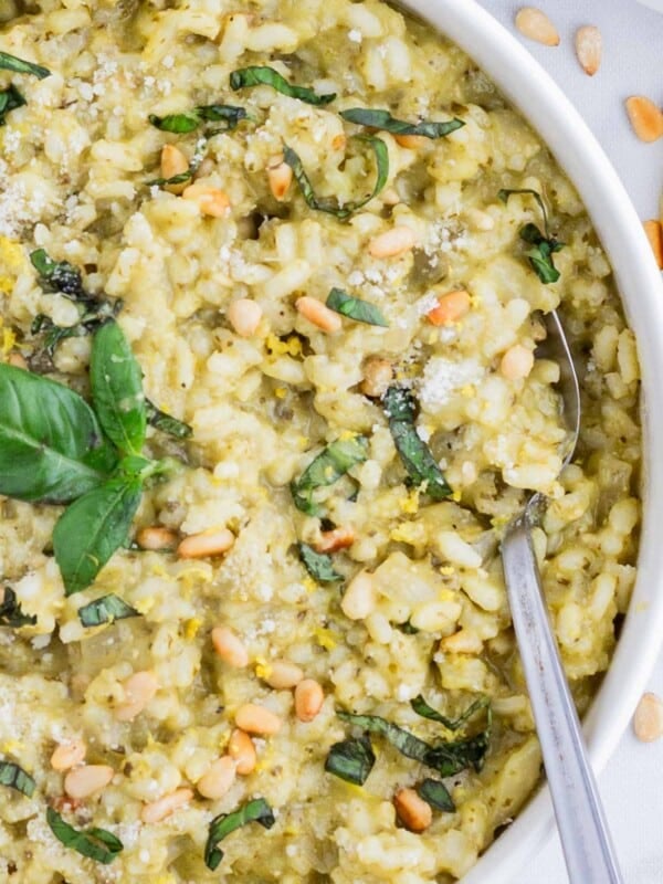 A spoon is used to serve pesto risotto.