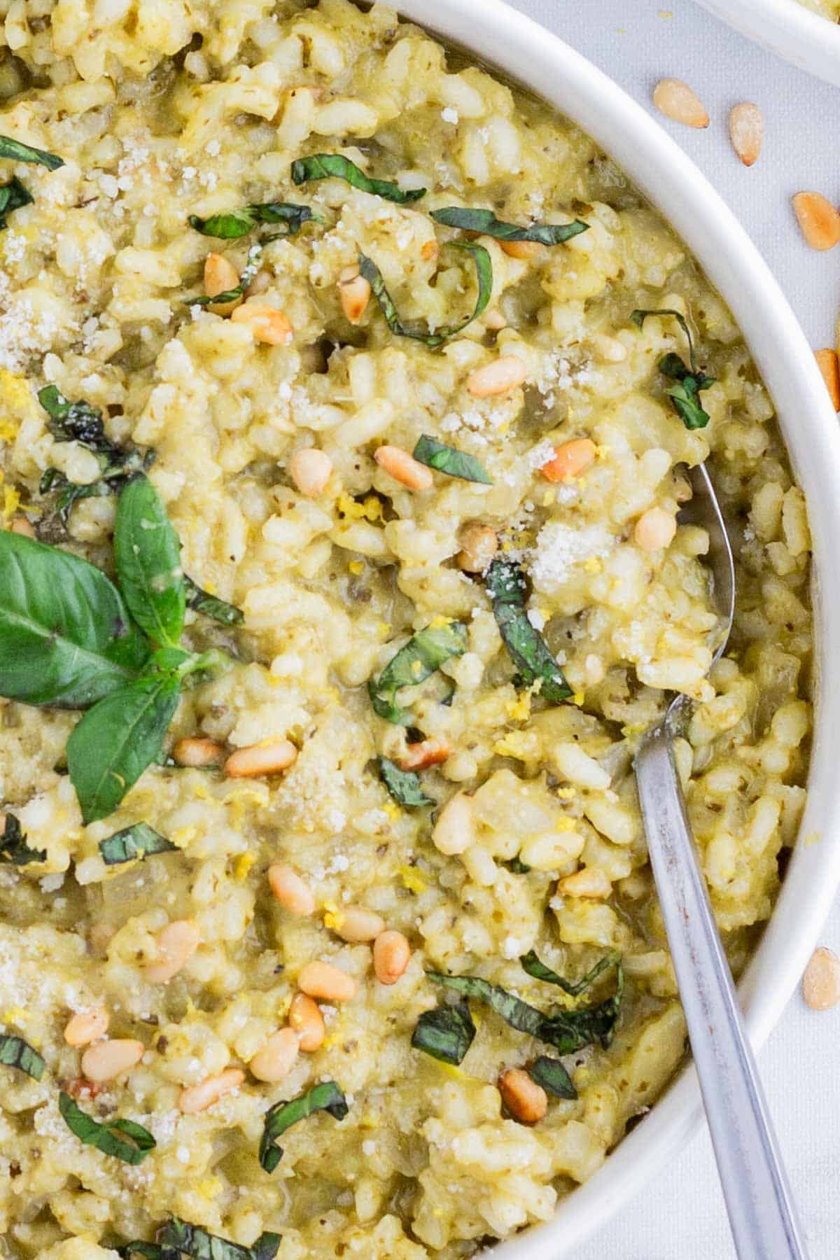 Pesto Risotto RECIPE served in a white bowl with a spoon.