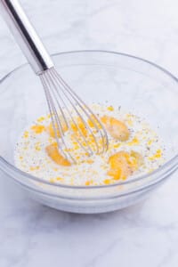 The batter ingredients are whisked together.