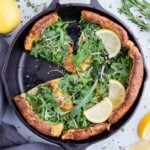 A savory Dutch baby is sliced before serving.