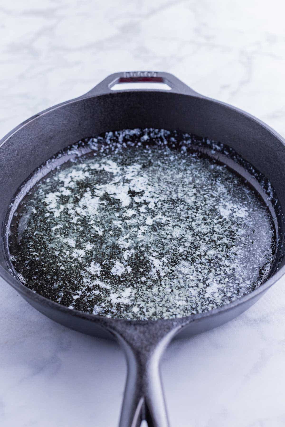 The butter is melted in a hot skillet in the oven.