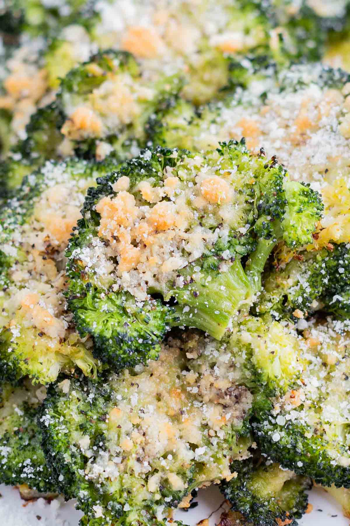 Smashed broccoli is cooked with Parmesan cheese for a crispy side dish.