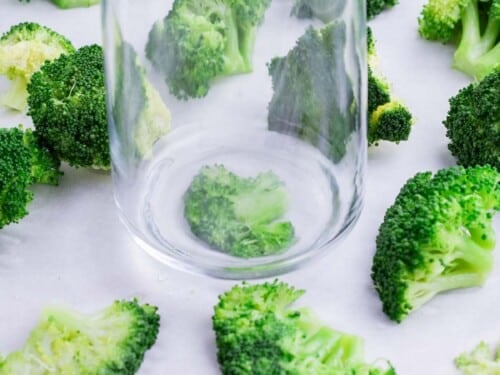 Boiled broccoli is smashed with the bottom of the glass.