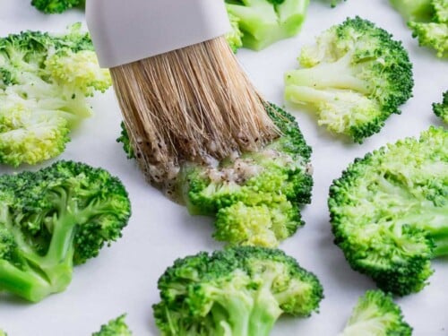 The butter mixture is spread over the top of the smashed broccoli.